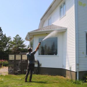 Professional power washing deck surface to remove mildew and dirt